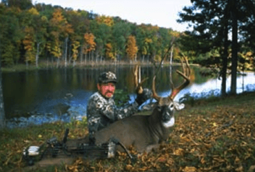 Bow Hunter With Big Buck 